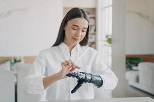 Young disabled girl turns on her bionic prosthetic arm, training to use artificial robotic hand photo