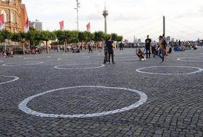 Dusseldorf, NRW, Germany, 2020 - Numerous white circles painted on the floor to encourage social distancing in Dusseldorf, Germany photo