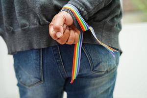 mujer asiática con bandera del arco iris, derechos de símbolos lgbt e igualdad de género, mes del orgullo lgbt en junio. foto