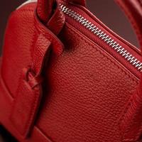 A closeup shot of a luxury red leather bag photo