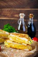 Roasted French toast with ham, egg, herbs and cheese cheddar. Delicious grilled breakfast sandwich