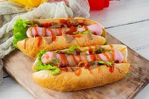 Delicious hot dog with ketchup and mustard on wooden background. Street food photo