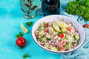 Vegetarian tabbouleh salad with couscous, parsley, cucumber, tomato. Traditional middle eastern or arabic cuisine photo