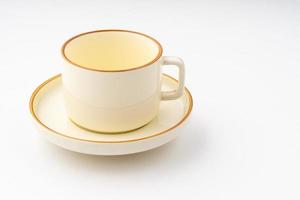 A set of white and brown ceramic plate and cup on a white background photo