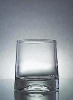 A vertical shot of an empty glass on a grey background photo