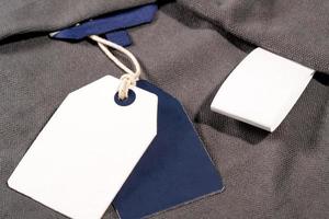 A closeup shot of white blue clothing tags on a string with copy space and a blank tag photo