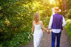 Young couple walking in the Park holding hands photo