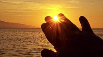 Hand Gesture Toward The Sun At Sunset video