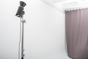 interior of bright space of photo studio with large white cyclorama with lighting equipment