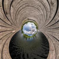 blue sphere little planet inside transformation of wooden pier and lake. photo