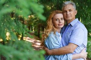 Old age, relationships and people concept happy senior couple hugging in city photo