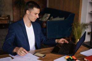 Portrait banking finance analyst in jacket working in home office on laptop photo