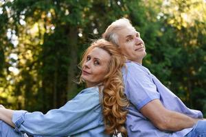 Portrait handsome mature man woman couple sitting back each other rest photo