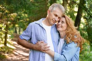 Old age, relationships and people concept happy senior couple hugging in city photo