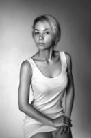 portrait of a young woman on a dark background looking away, black and white photo