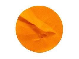 Blank orange round adhesive paper sticker label isolated on white background photo