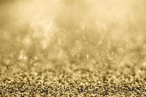 Abstract gold glitter sparkle blurred with bokeh background photo