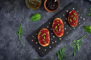 Bruschetta with grated beetroot, herbs and caramelized onion. Top view photo