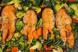 Baked salmon fillet with green vegetables. Fillet fish with herbs and vegetables photo