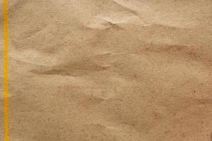 Brown crumpled paper recycled kraft sheet texture background photo