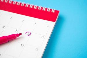 important appointment schedule write on white calendar page date on blue background photo