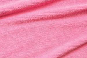 Pink towel fabric texture surface close up background photo