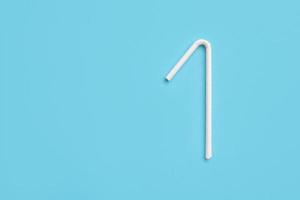 Biodegradable eco friendly white paper drinking straw on blue background photo