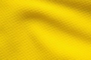 Yellow sports clothing fabric football shirt jersey texture close up photo