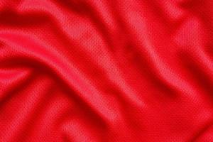 Fondo de textura de jersey de camiseta de fútbol de tela de ropa deportiva roja foto