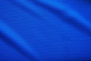 Blue football jersey clothing fabric texture sports wear background, close up top view photo