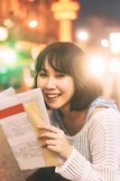 Portrait of young adult asian woman with 80s style japanese fashion witn night city neon bokeh photo