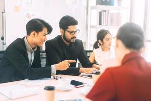 Business man with beard ceo look sitting and discussion strategy with team in boardroom photo