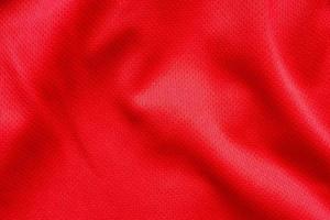 Fondo de textura de jersey de camiseta de fútbol de tela de ropa deportiva roja foto