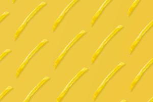 french fries pattern on yellow background top view flat lay photo