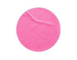 Blank pink round adhesive paper sticker label isolated on white background photo