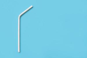 Biodegradable eco friendly white paper drinking straw on blue background photo