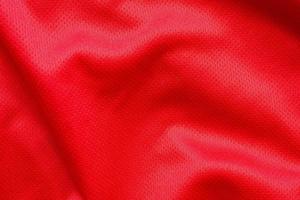 Fondo de textura de jersey de camiseta de fútbol de tela de ropa deportiva roja foto