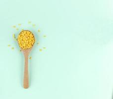 Top view spoon of  hulled split mung beans on light blue background photo