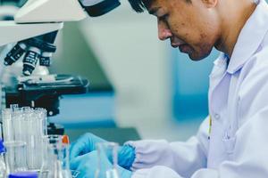 Asian male medical or scientific researcher or doctor Working in The Laboratory.Advanced Scientific Lab for Medicine, Biotechnology, Microbiology Development