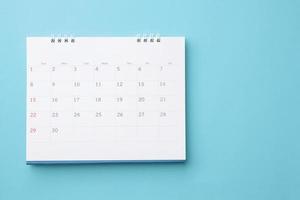 desk calendar on blue background business planning appointment meeting concept photo