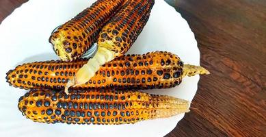 Roasted corns, one of the typical street foods in india, eaten with salt and lemon. photo