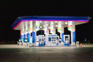 Petrol gas station at night time blurred background with bokeh light photo