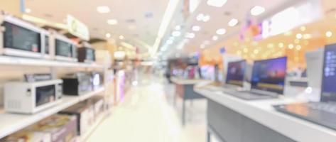 electronic department store show laptop computer and home appliance with bokeh light blurred background photo