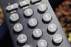 Close up view on the number keys of a Television remote control. photo