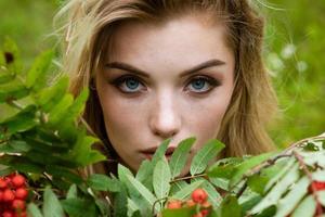 Portrait of a beautiful woman with a bouquet of rowan photo