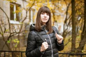 Portrait of a cute young woman in autumn on a Sunny day photo