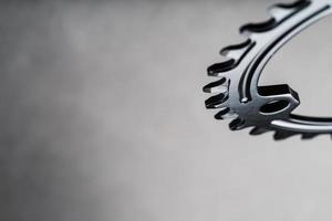 A black bicycle driving star with contrasting repeating cogs on a dark background photo