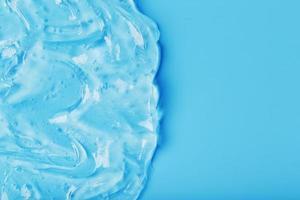 Antiseptic gel on a blue background in waves. photo