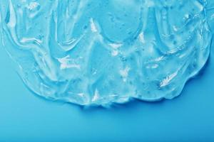 Antiseptic gel on a blue background in waves. photo