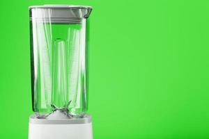 Electric blender with an empty jug on a green background. photo